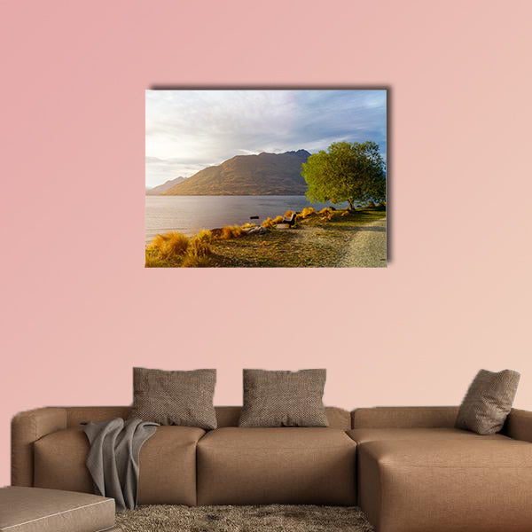 Wooden bench under tree on glowing sunset at Lake Wakatipu wall art