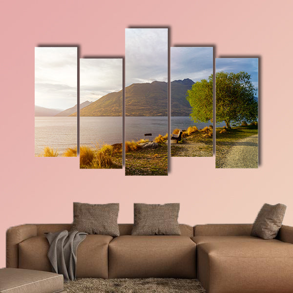 Wooden bench under tree on glowing sunset at Lake Wakatipu wall art
