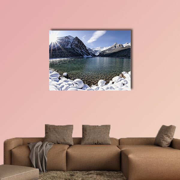 Sun shining over Lake Louise, Alberta in the Canadian Rockies in winter multi panel canvas wall art