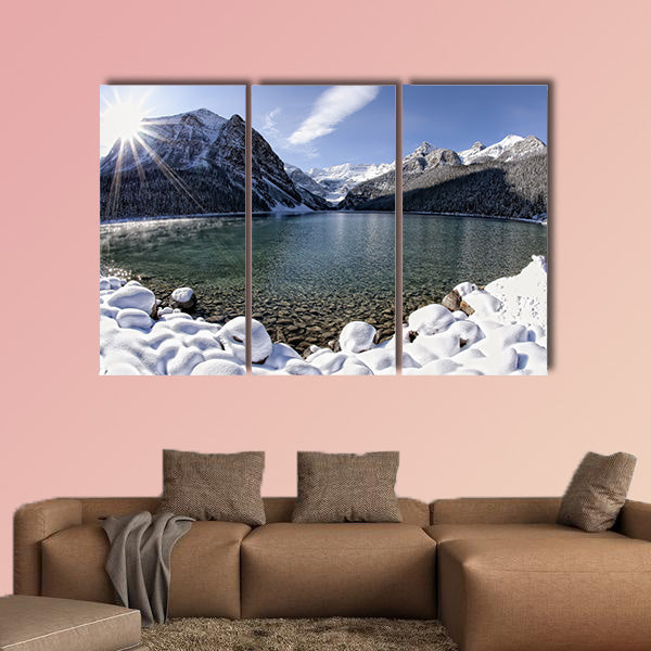Sun shining over Lake Louise, Alberta in the Canadian Rockies in winter multi panel canvas wall art