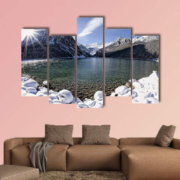 Sun shining over Lake Louise, Alberta in the Canadian Rockies in winter multi panel canvas wall art