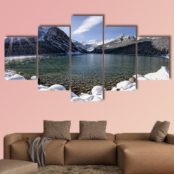 Sun shining over Lake Louise, Alberta in the Canadian Rockies in winter multi panel canvas wall art