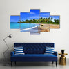 Jamaica. A national boat on sandy coast of a bay Multi panel canvas wall art