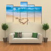 Heart with arrow, as love sign, drawn on the beach shore multi panel canvas wall art