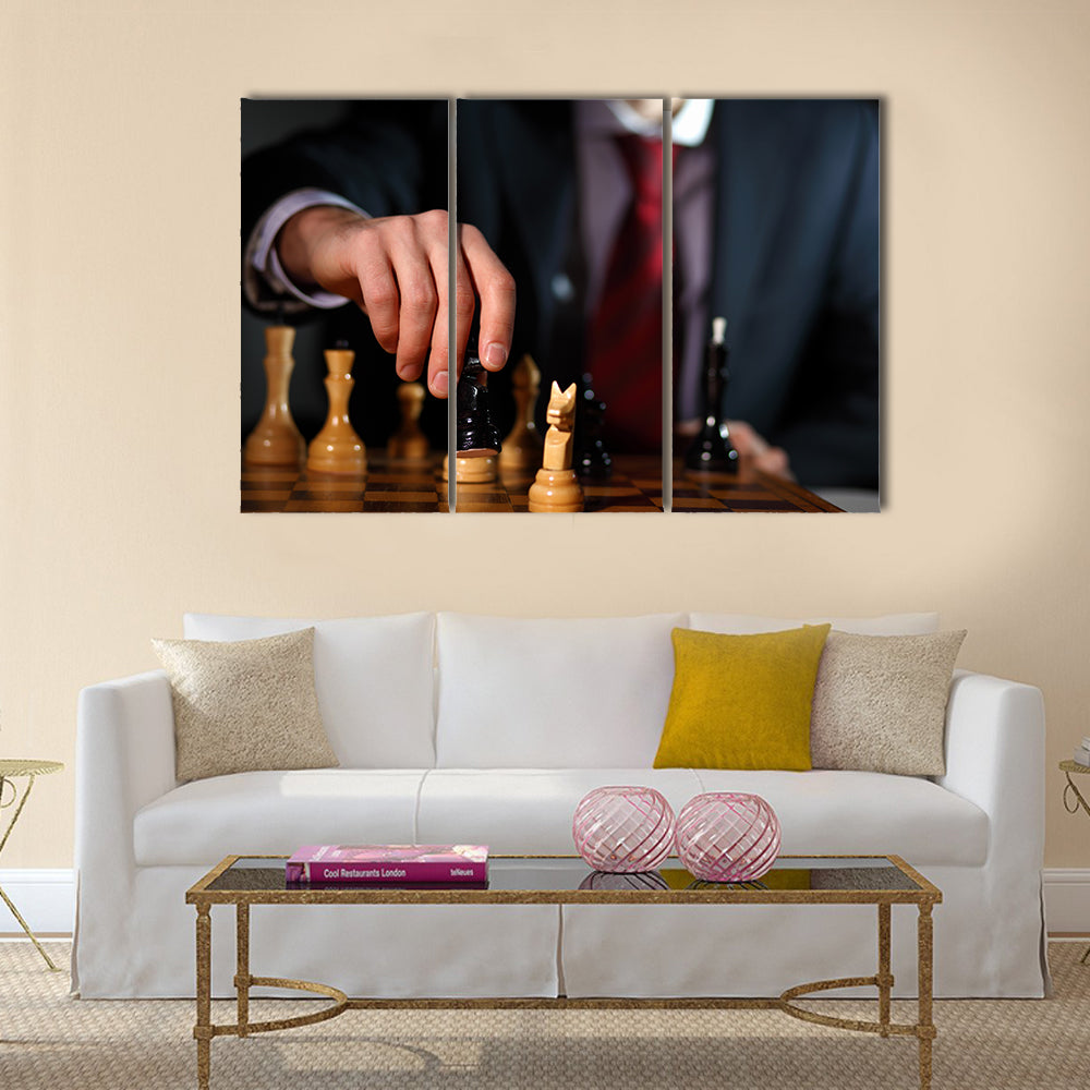 Canvas of a businessman in dark suit playing chess multi panel canvas wall art