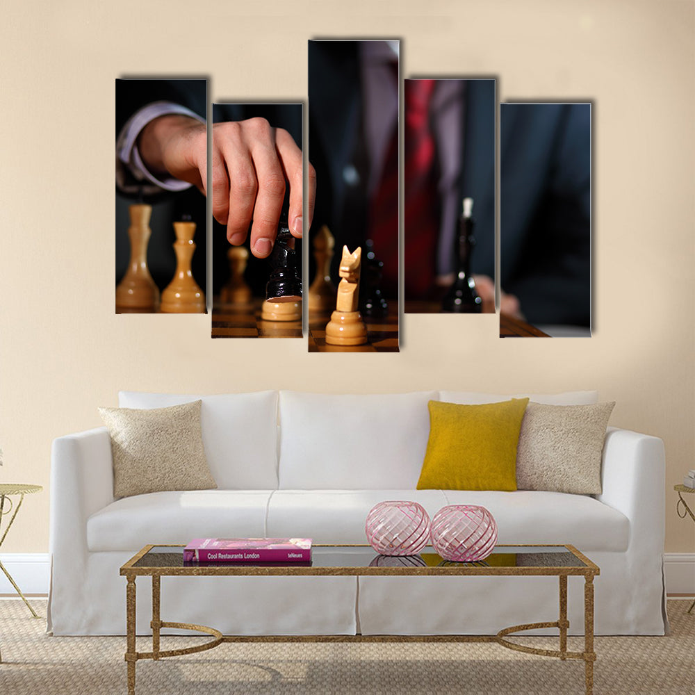 Canvas of a businessman in dark suit playing chess multi panel canvas wall art