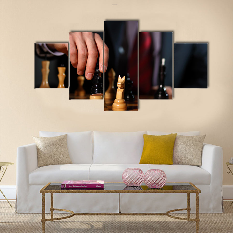 Canvas of a businessman in dark suit playing chess multi panel canvas wall art