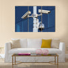 Three cctv security cameras on street pylon Multi panel canvas wall art