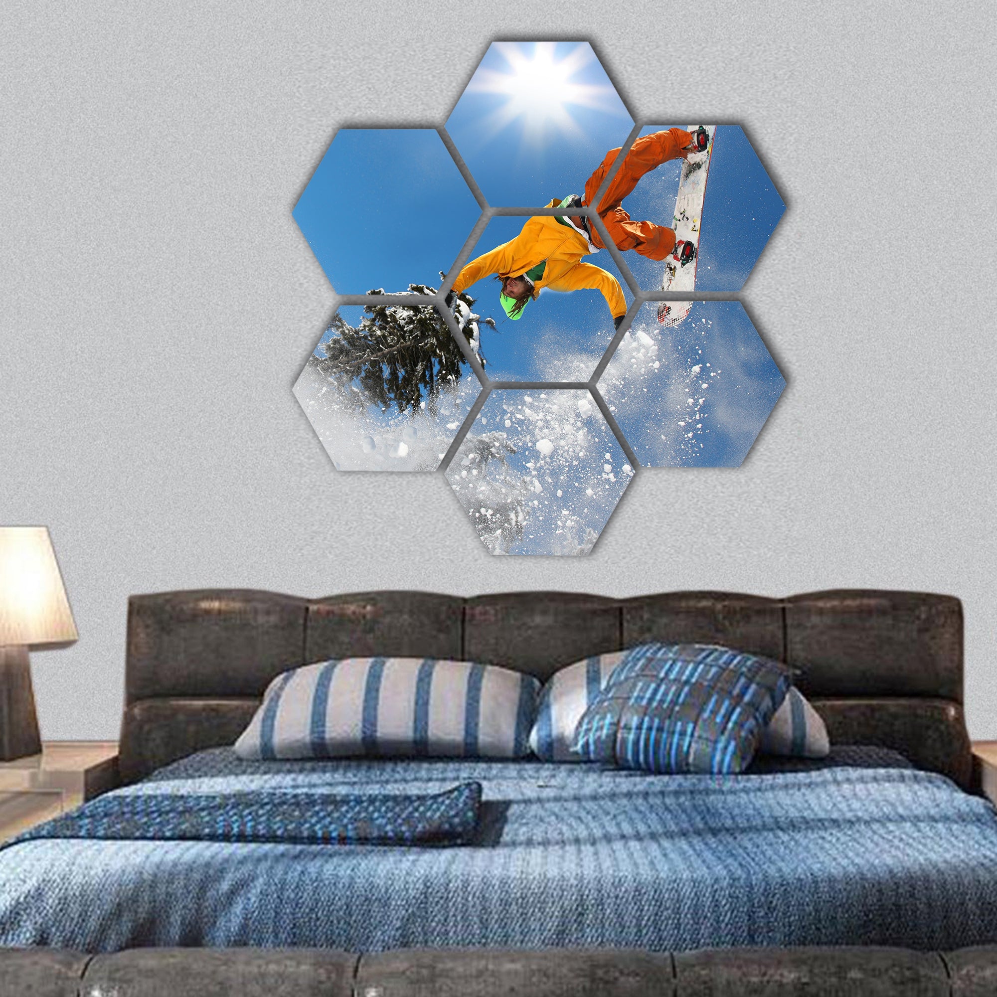 Snowboarder jumping against blue sky hexagonal canvas wall art