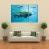 A Goliath Grouper Swims with Other Fish Multi Panel Canvas Wall Art