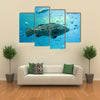 A Goliath Grouper Swims with Other Fish Multi Panel Canvas Wall Art