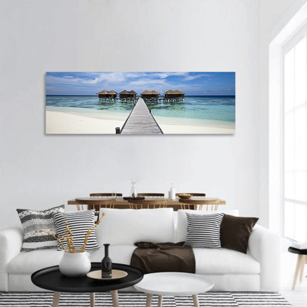 Hotel in island with white sand beach, blue lagoon, panoramic canvas wall art