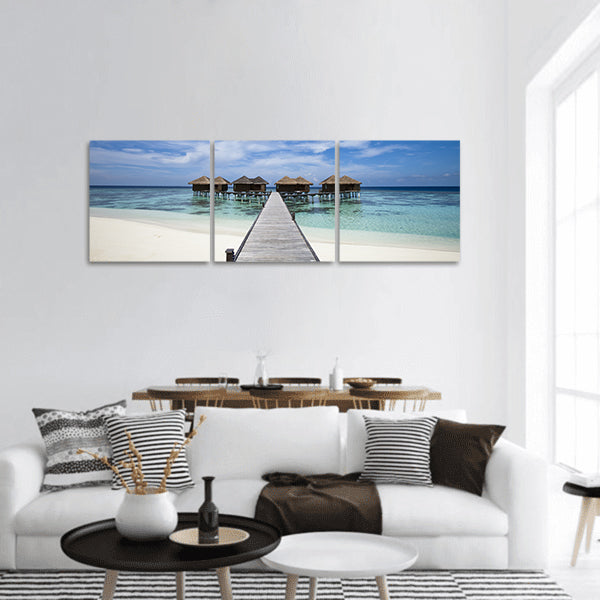 Hotel in island with white sand beach, blue lagoon, panoramic canvas wall art