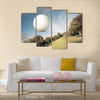 Golf ball flying over green field Multi Panel Canvas Wall Art