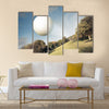 Golf ball flying over green field Multi Panel Canvas Wall Art