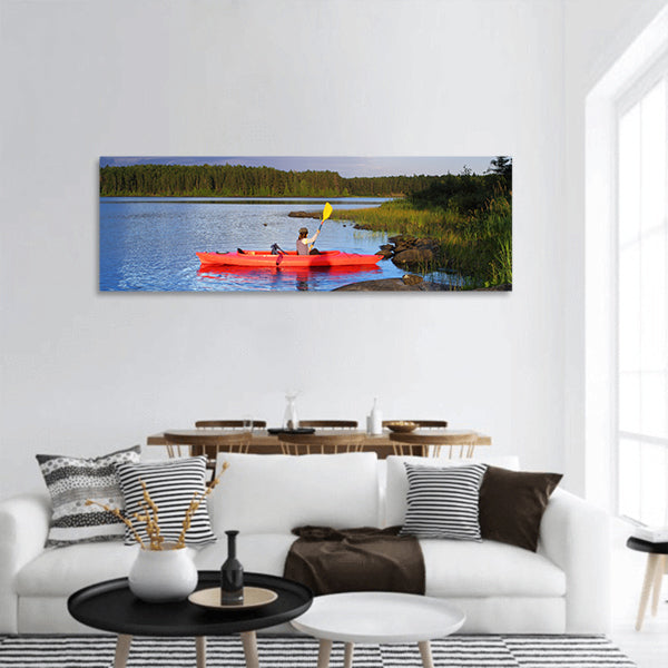 Woman canoeing in a beautiful lake at sunset panoramic canvas wall art