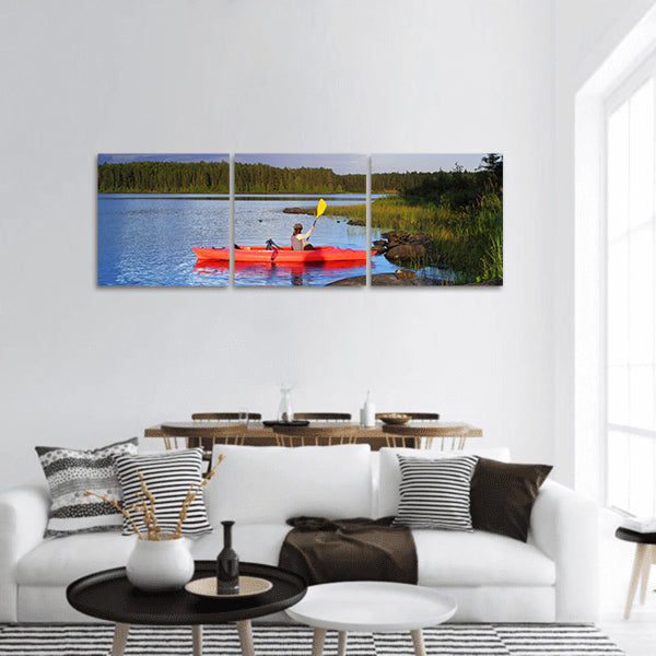 Woman canoeing in a beautiful lake at sunset panoramic canvas wall art