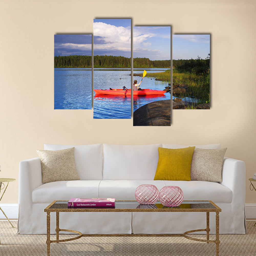 Woman canoeing in a beautiful lake at sunset Multi panel canvas wall art