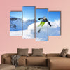 Skier skiing downhill on fresh powder snow with sun and mountains wall art