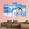 Skier skiing downhill on fresh powder snow with sun and mountains wall art