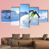 Skier skiing downhill on fresh powder snow with sun and mountains wall art