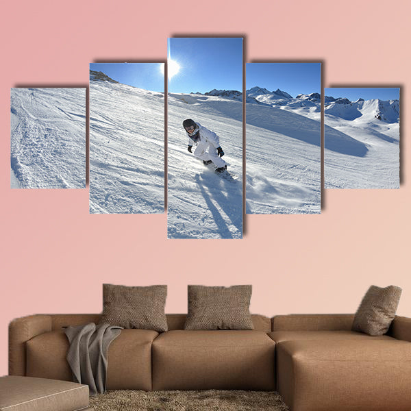 Skier skiing downhill on fresh powder snow with sun and mountains wall art