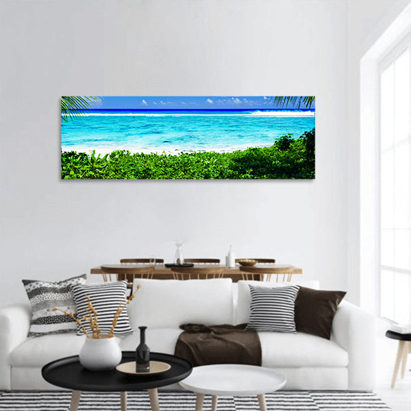 Deserted tropical beach lagoon framed by palm trees panoramic canvas wall art