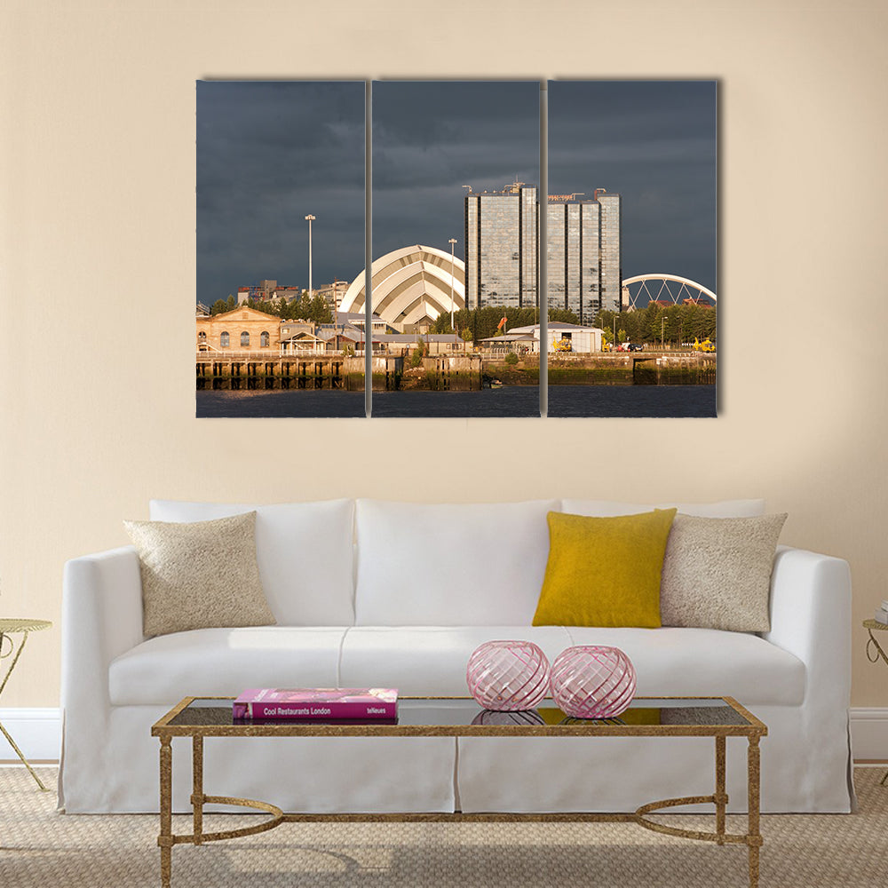 Sunlight on buildings as storm clouds gather beside River Clyde in Glasgow, UK, Multi Panel Canvas Wall Art