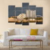 Sunlight on buildings as storm clouds gather beside River Clyde in Glasgow, UK, Multi Panel Canvas Wall Art