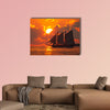 A boat sailing in front of a beautiful sunset in Key West, Florida multi panel canvas wall art