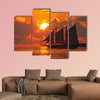 A boat sailing in front of a beautiful sunset in Key West, Florida multi panel canvas wall art