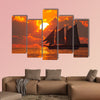 A boat sailing in front of a beautiful sunset in Key West, Florida multi panel canvas wall art