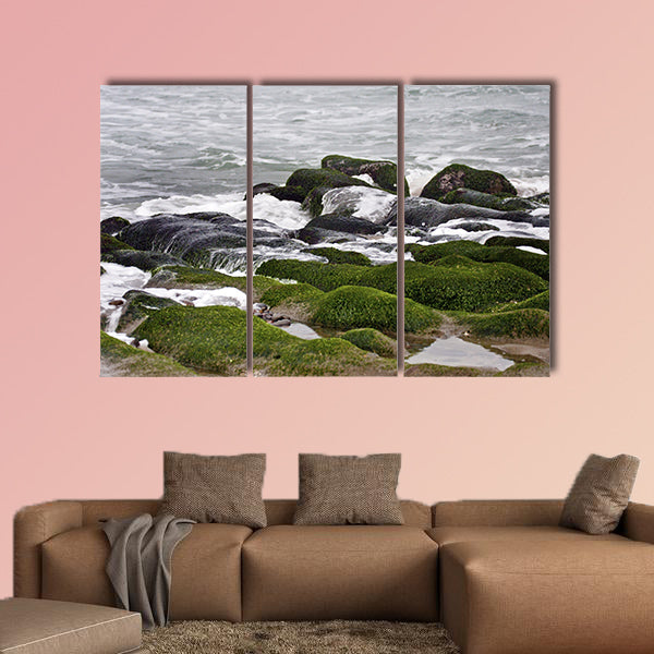 Stunning view of surf on green rock multi panel canvas wall art