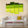 Golf ball on green near to the hole with red flag Multi Panel Canvas Wall Art