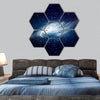 Glowing galaxy against black space and stars hexagonal canvas wall art