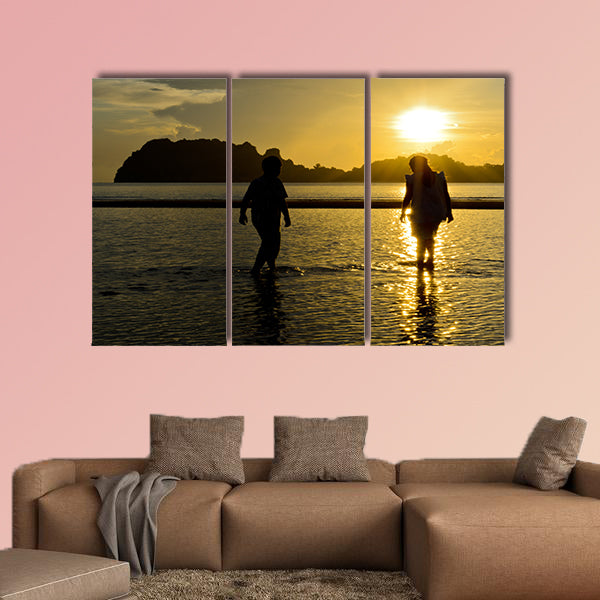 Boys and girls playing on the beach at sunrise Multi panel canvas wall art