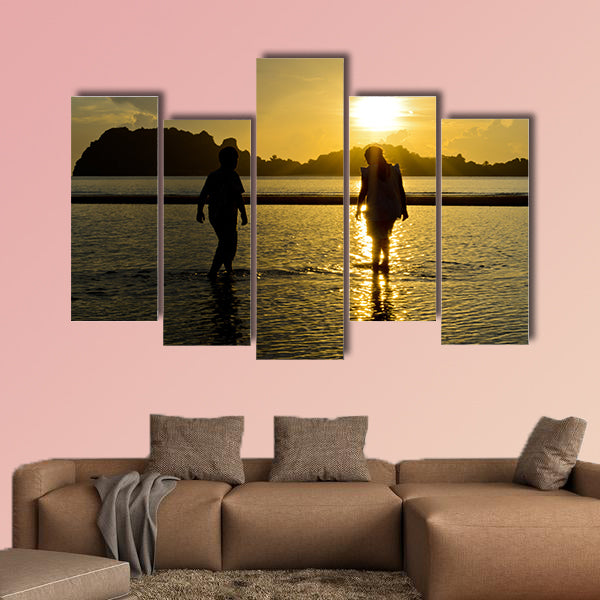 Boys and girls playing on the beach at sunrise Multi panel canvas wall art