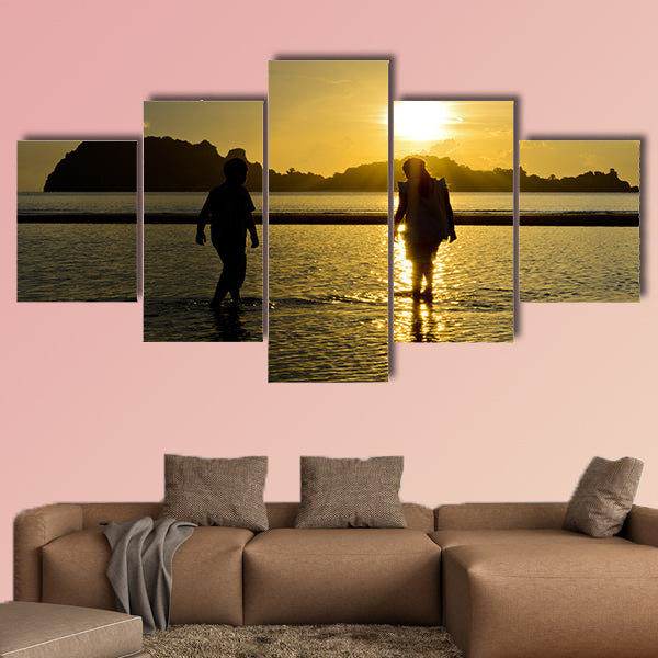 Boys and girls playing on the beach at sunrise Multi panel canvas wall art
