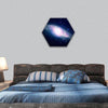 Glowing galaxy against black space and stars hexagonal canvas wall art