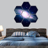 Glowing galaxy against black space and stars hexagonal canvas wall art