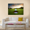 Golf ball about to fall into the cup at sunset Multi Panel Canvas Wall Art