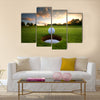 Golf ball about to fall into the cup at sunset Multi Panel Canvas Wall Art