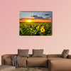 Field of blooming sunflowers on a background sunset Multi panel canvas wall art