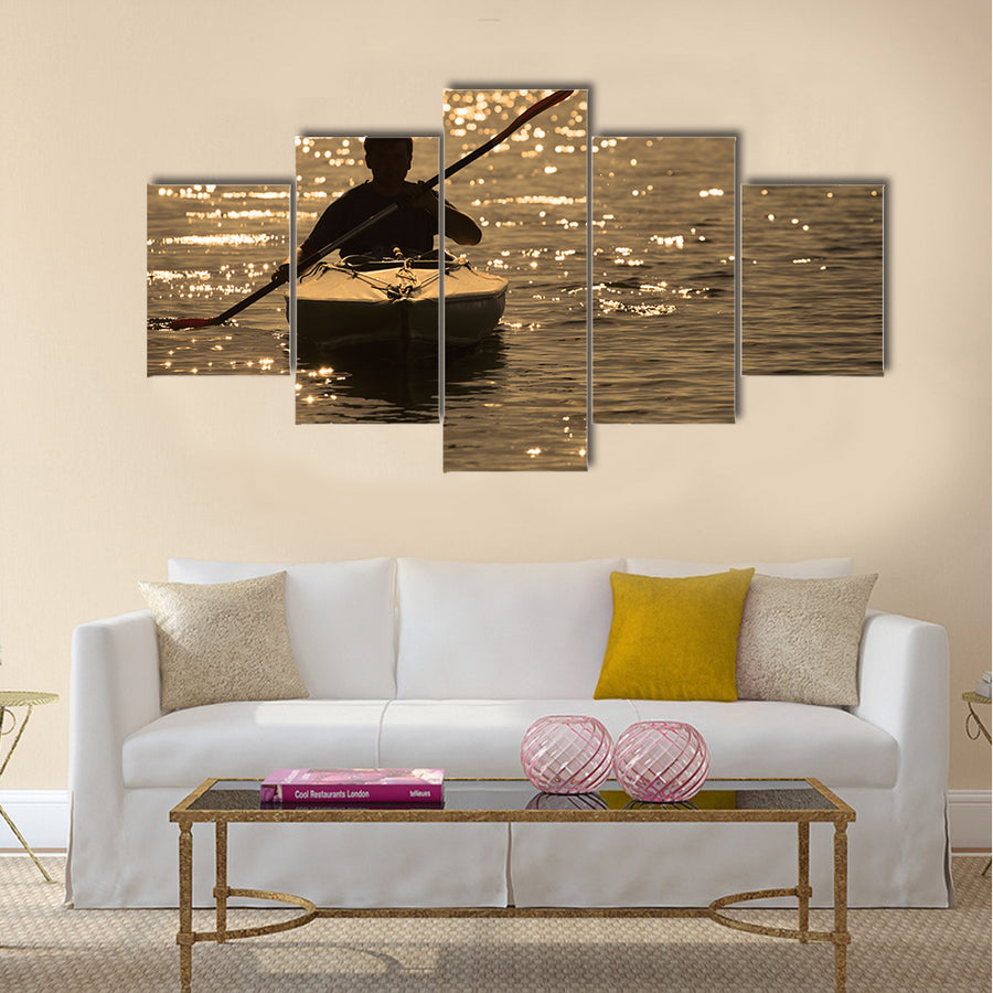 Silhouette of a man rowing in the canoe Multi panel canvas wall art