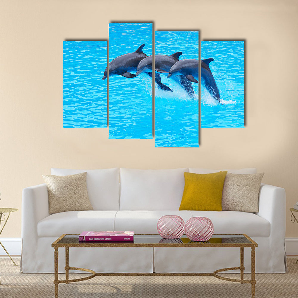 Three Bottlenose Dolphins, Tursiops truncatus, leaping in formation Multi Panel Canvas Wall Art