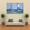 Back view of two windsurfers in action moving parallel to eath other Multi panel canvas wall art