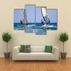 Back view of two windsurfers in action moving parallel to eath other Multi panel canvas wall art