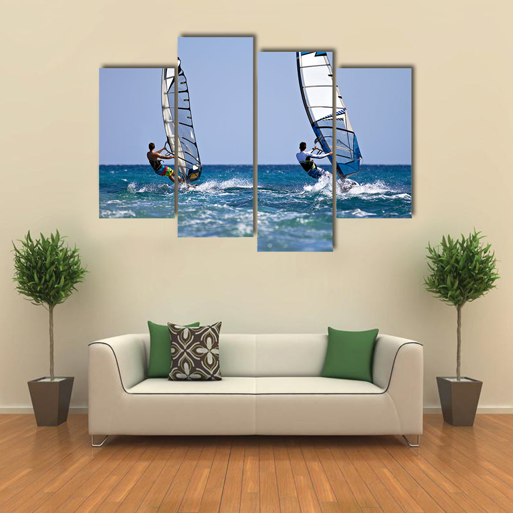 Back view of two windsurfers in action moving parallel to eath other Multi panel canvas wall art