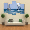 Back view of two windsurfers in action moving parallel to eath other Multi panel canvas wall art