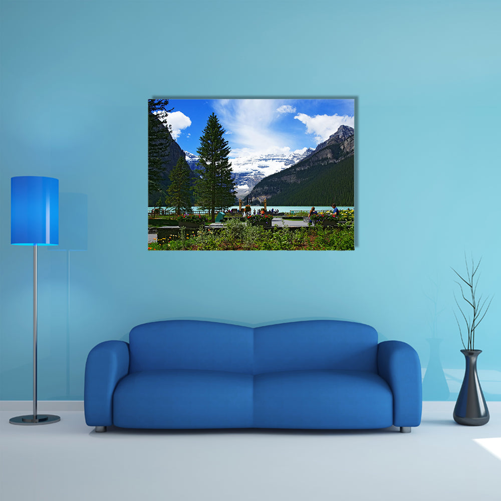 People chilling out and dating in front of Lake Louise, seen from the Fairmont Chateau Lake Louise hotel multi panel canvas wall art